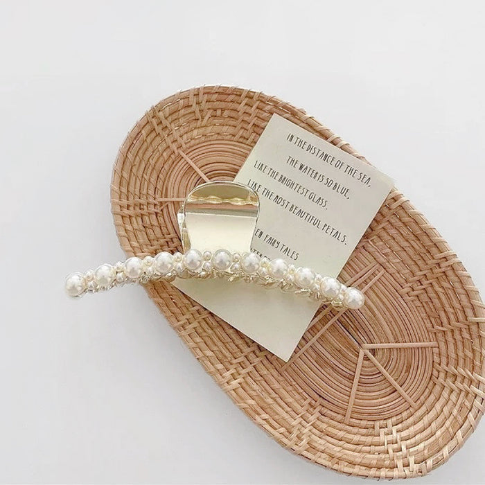Angled view of Pearl Elegance Hair Claw hair claw clip in ivory hair accessory, great for everyday styling and gifting.