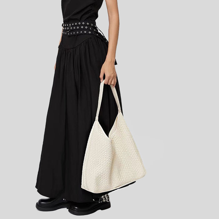 Model carrying the white pebble texture shoulder bag for an elegant look.