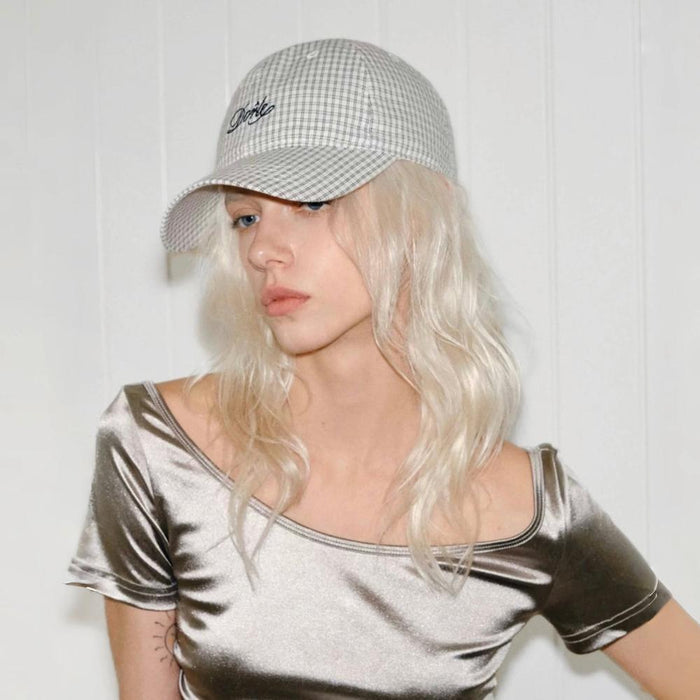 Model wearing light grey Plaid Chill Cap with Spirit embroidery, featuring soft breathable cotton for daily wear.