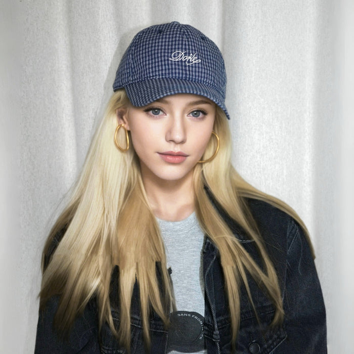 Model wearing navy blue Plaid Chill Cap, showcasing classic plaid patterns for a timeless, rugged outdoor look.