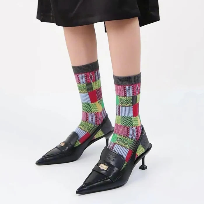 Model wearing a pair of  Patchwork Socks in gray, easy to pack for travel and errands.