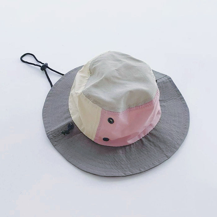 Flatlay of the grey and pink plant-inspired brimmed hat on a white background.