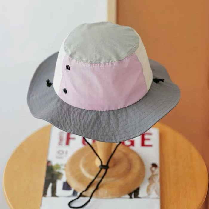 Angled side view of the grey and pink outdoor hat highlighting its wide brim.