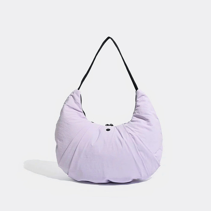 Angled view of Light purple pleated nylon crescent shoulder bag with black strap and zip-top fastening.