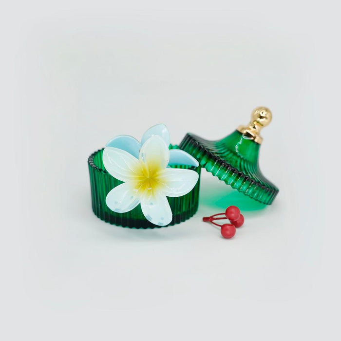 Flat lay of Plumeria Hair Claw  in blue, great for everyday styling and gifting.