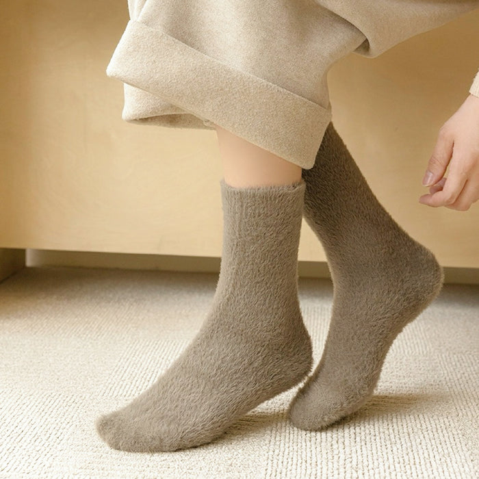 Model wearing a pair of dark khaki Plush Cozy Socks, great for casual wear and light workouts.