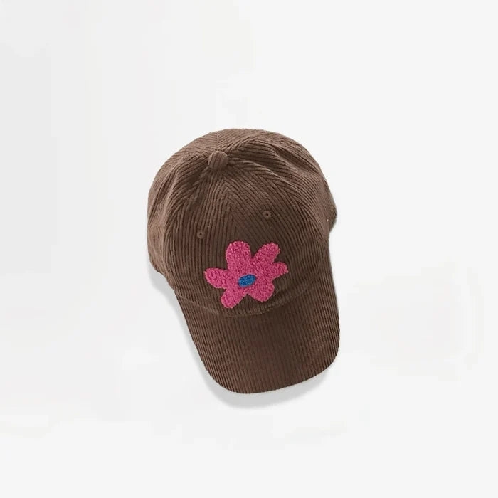 Brown corduroy baseball cap featuring a pink plush flower embroidery.