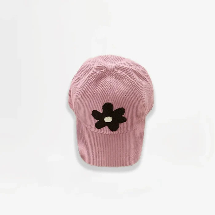 Pink corduroy baseball cap featuring a brown plush flower embroidery.