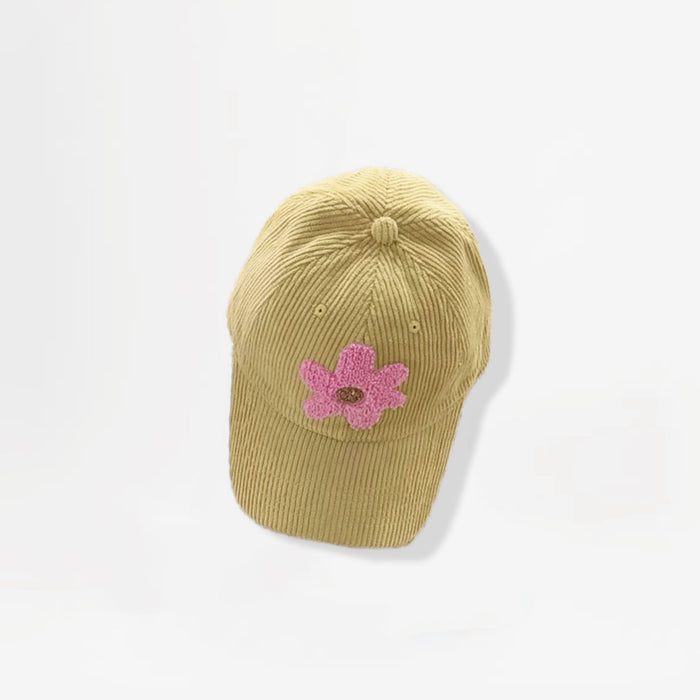 Mustard corduroy baseball cap featuring a pink plush flower embroidery.