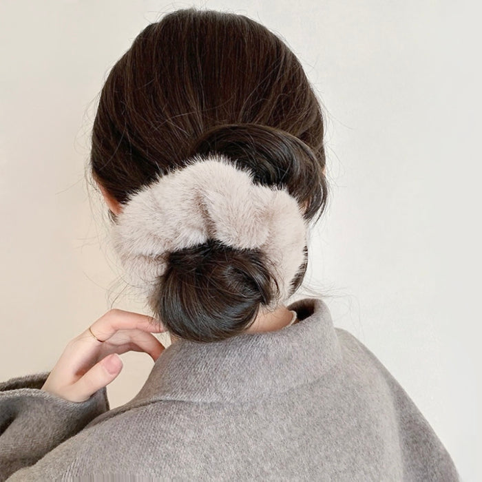 Model wearing Plush Scrunchie in beige, ideal for quick updos and ponytails.