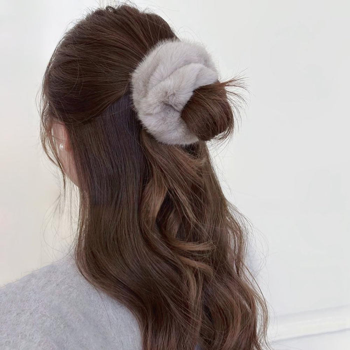 Model wearing  Plush Scrunchie in gray, great for everyday styling and gifting.