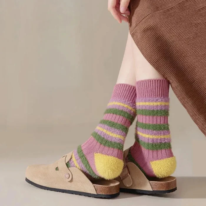 Model wearing a pair of Plush Striped Socks in purple, easy to pack for travel and errands.