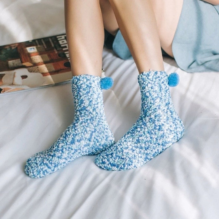 Model wearing a pair of Pompom Cupcake Socks in blue, great for daily wear and lounging.