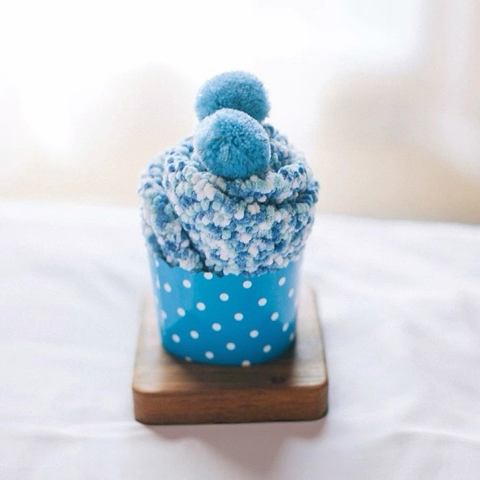 Folded view of Pompom Cupcake Socks in blue, ideal for workouts and commuting.