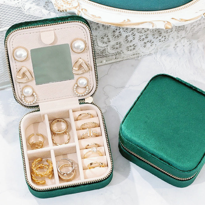 Front view of Open Emerald green velvet jewelry case with mirror, ring rolls, and compartments storage.