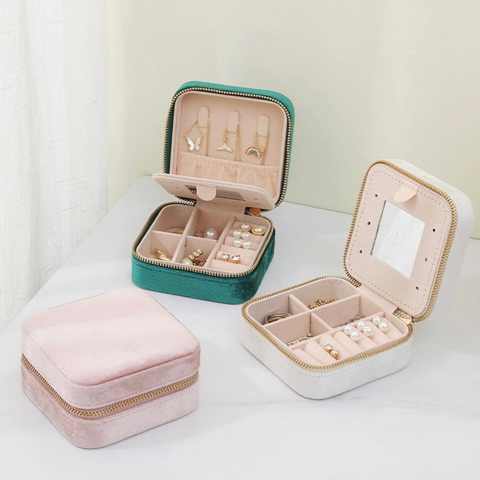 Three colors of Portable Velvet Jewelry Case storage organizer shown together, two open and one close.