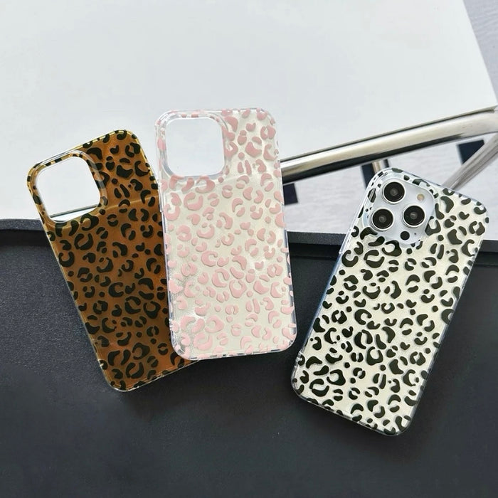 Three silicone leopard print cases in brown, pink, and black on clear backgrounds. Trendy Mob Wife style.