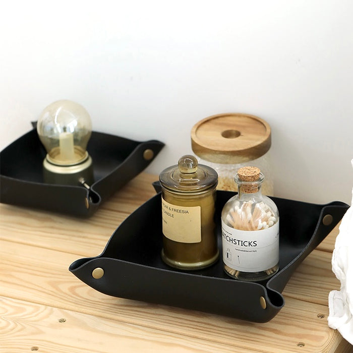 Close-up of  two black PU Leather Tray with bottles , ideal for tidy shelves and daily use.