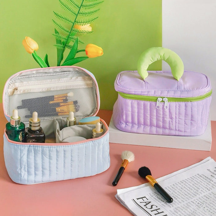 Front view of two Puffy Candy Makeup Boxes, light blue is open with cosmetics, purple one is closed.