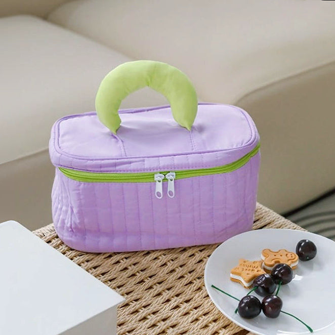 Angled view of purple Puffy Candy Makeup Box, great for on-the-go touch-ups.