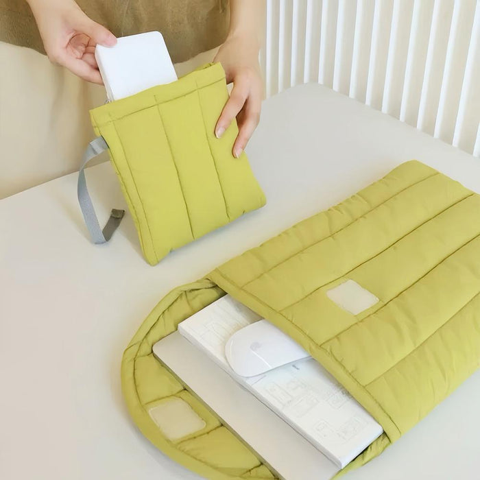 The model is demonstrating how to place a power supply unit into the power supply organizer pouch, with a laptop sleeve positioned nearby.