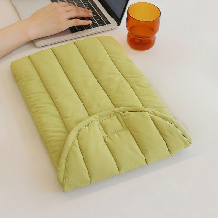 Olive yellow quilted puffy cotton laptop sleeve with a minimalist design.