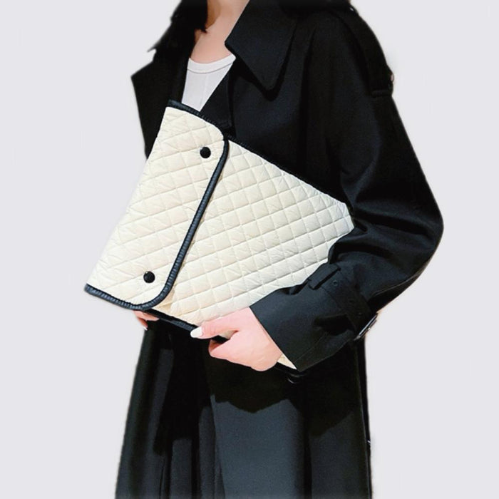 Model carrying a white cotton  laptop sleeves, easy for commuting and weekends.