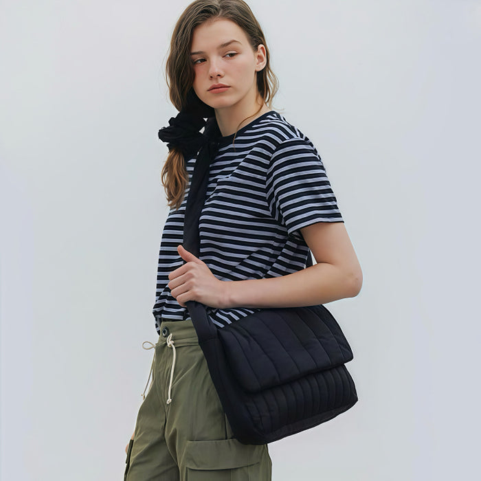 Model carrying a black Puffy Knot Quilted Bag as crossbody, easy for commuting and weekends.