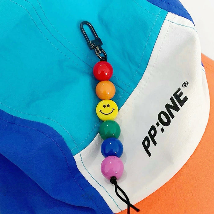 Angled view of Rainbow Smile Bead Link Bag Charm, easy to attach to bags and phones.