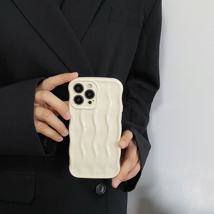 Hand holding the white 3D wave silicone phone case.
