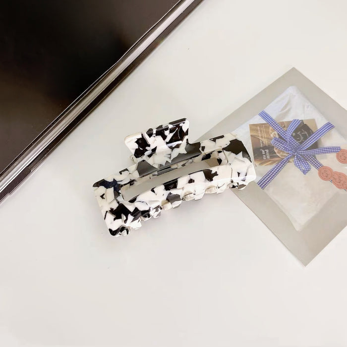 Angled view of Rectangle Hair Claw  in black, ideal for quick updos and ponytails.