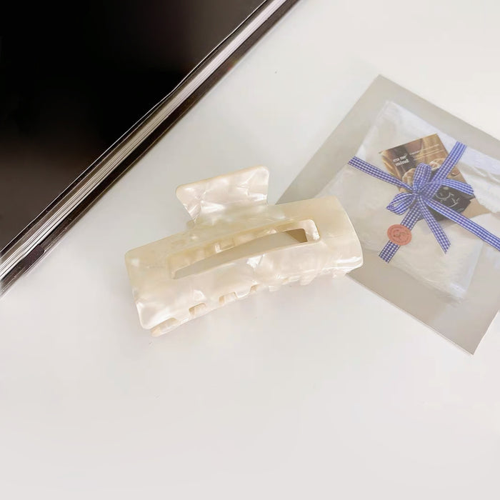 Angled view of Rectangle Hair Clawin white, great for everyday styling and gifting.