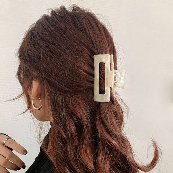 Model wearing Rectangle Hair Claw in white, ideal for quick updos and ponytails.