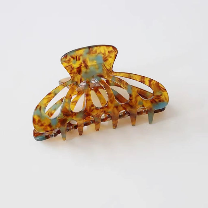 Flat lay of Retro Hair Claw in latern shape , great for everyday styling and gifting.