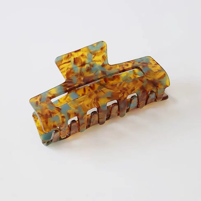 Angled view of Retro Hair Claw in rectangle shape , easy for workdays and special occasions.