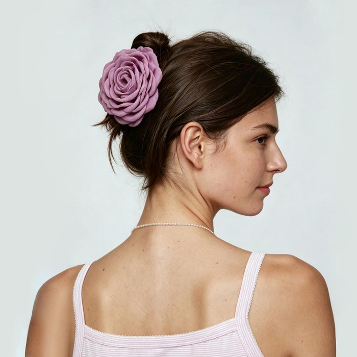 Side view of a model featuring a mauve  rose hair claw clip .
