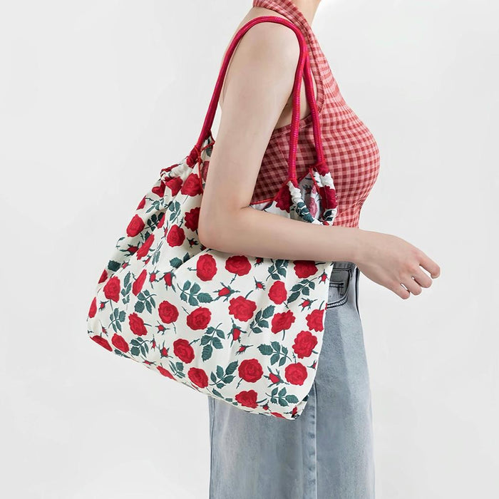 Model carrying a Rose Romance Tote Bag, great for everyday carry and travel.