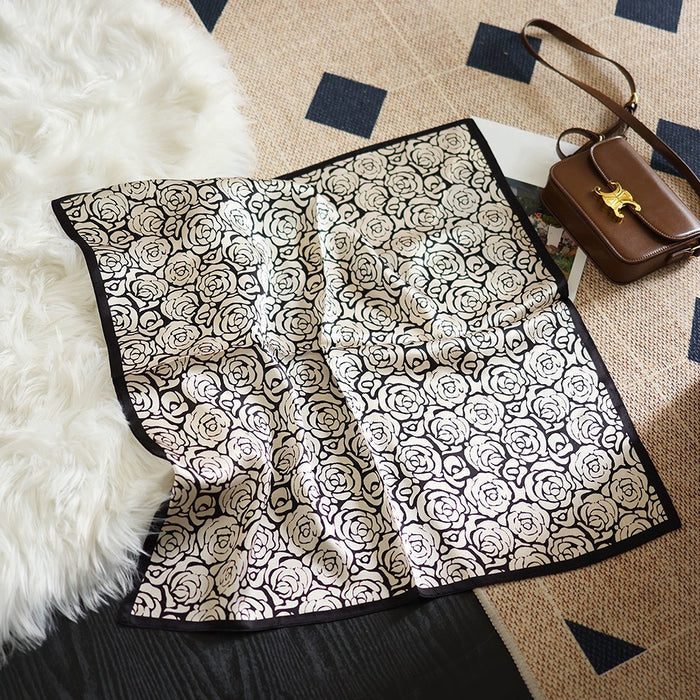 Front view of Rose silk scarf, with a black and white rose pattern, great for office layering.
