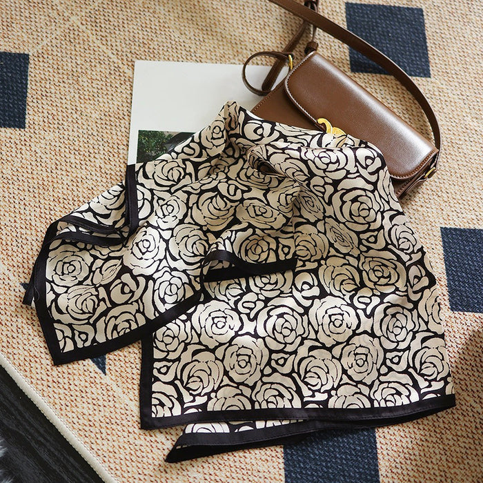 Flat lay of Rose Silk Scarf, great for office layering and commuting.