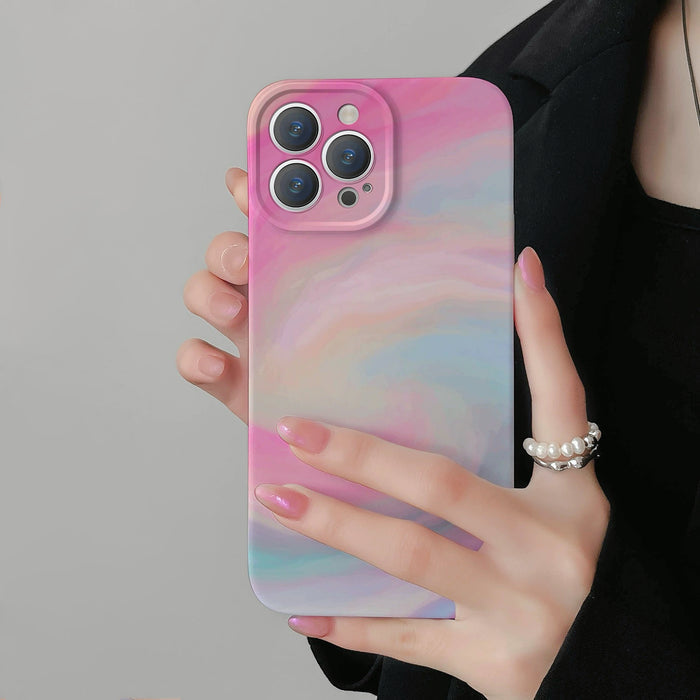 Held in hand, Rosy Dawn case with a pink, blue, and white watercolor swirl design. Dreamy aesthetic.