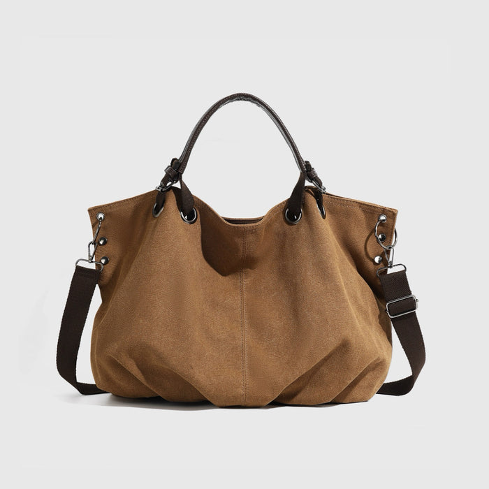 Front view of the brown rugged cargo canvas tote bag with leather trim.