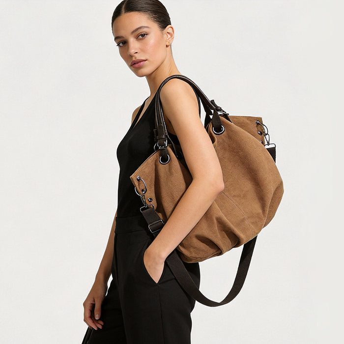 Model wearing the brown canvas tote bag as shoulder bag.