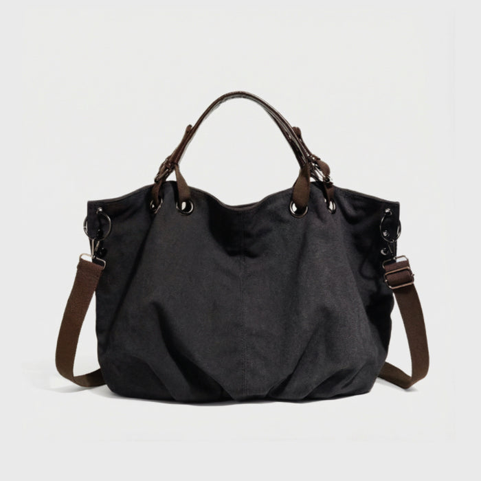 Front view of the black rugged cargo canvas tote bag with leather trim.