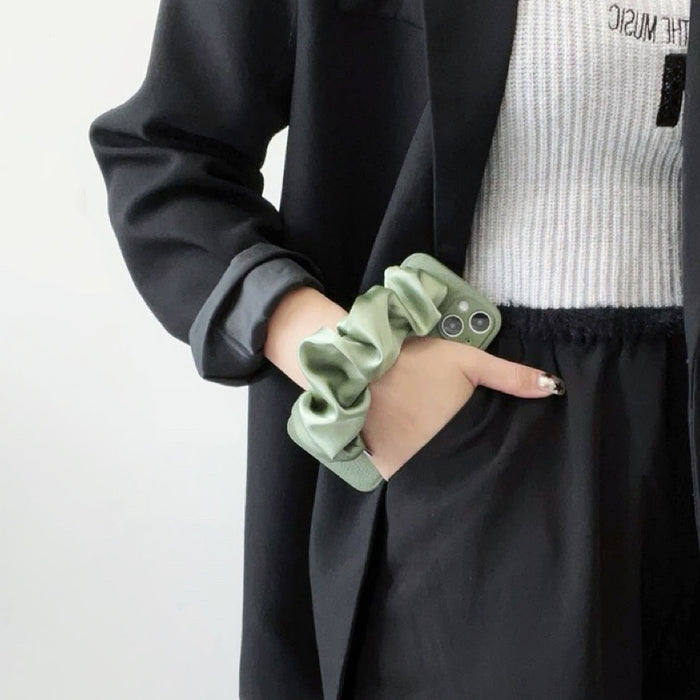 Front view of Green Satin Wristband Case. Emerald satin-texture wristlet integrated on a protective base.