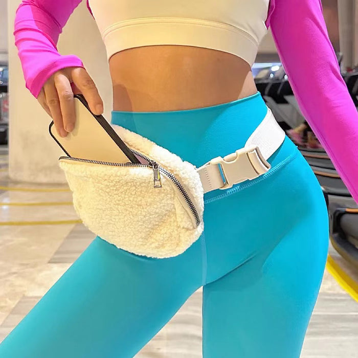 Model wearing a white sherpa belt bag paired with colorful yoga leggings; trendy cozy-core accessory for morning coffee runs.