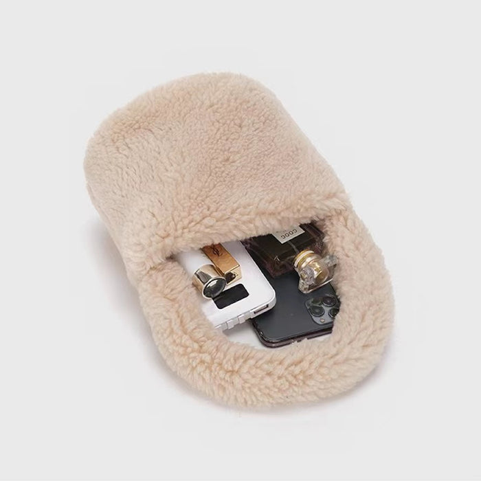 Angled view of apricot sherpa bucket handbag with phone, perfume, and lighter inside, easy for commuting.