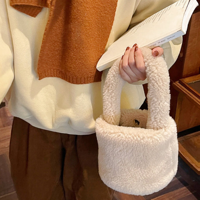 Model carrying a apricot Sherpa Bucket Handbag handheld, ideal for city walks and gifting.