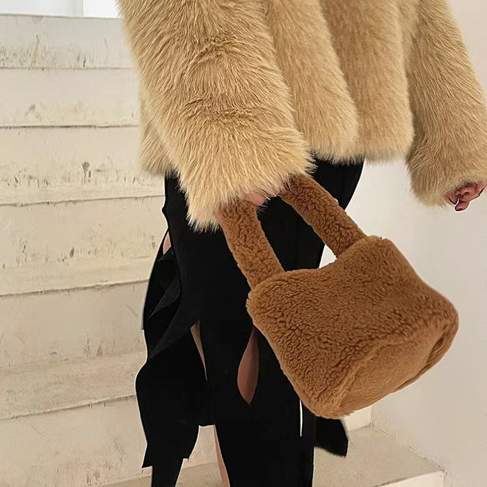 Model carrying a Sherpa Bucket Handbag in brown, great for everyday carry and travel.