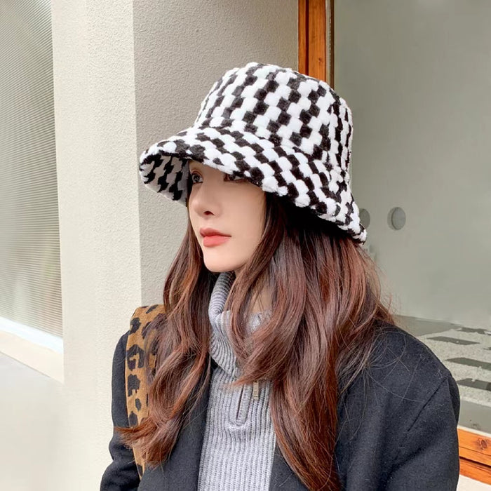 Model wearing Sherpa Checkered Bucket Hat in black, featuring a bold pattern in ultra-soft insulating polyester.