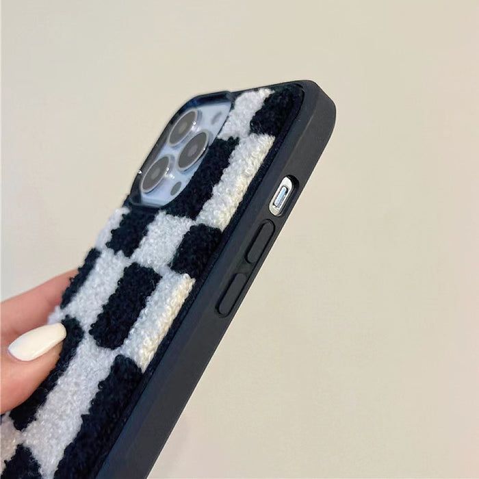 Close-up of Sherpa Checkered Case in Black. Detailed plush texture on a resilient silicone frame.